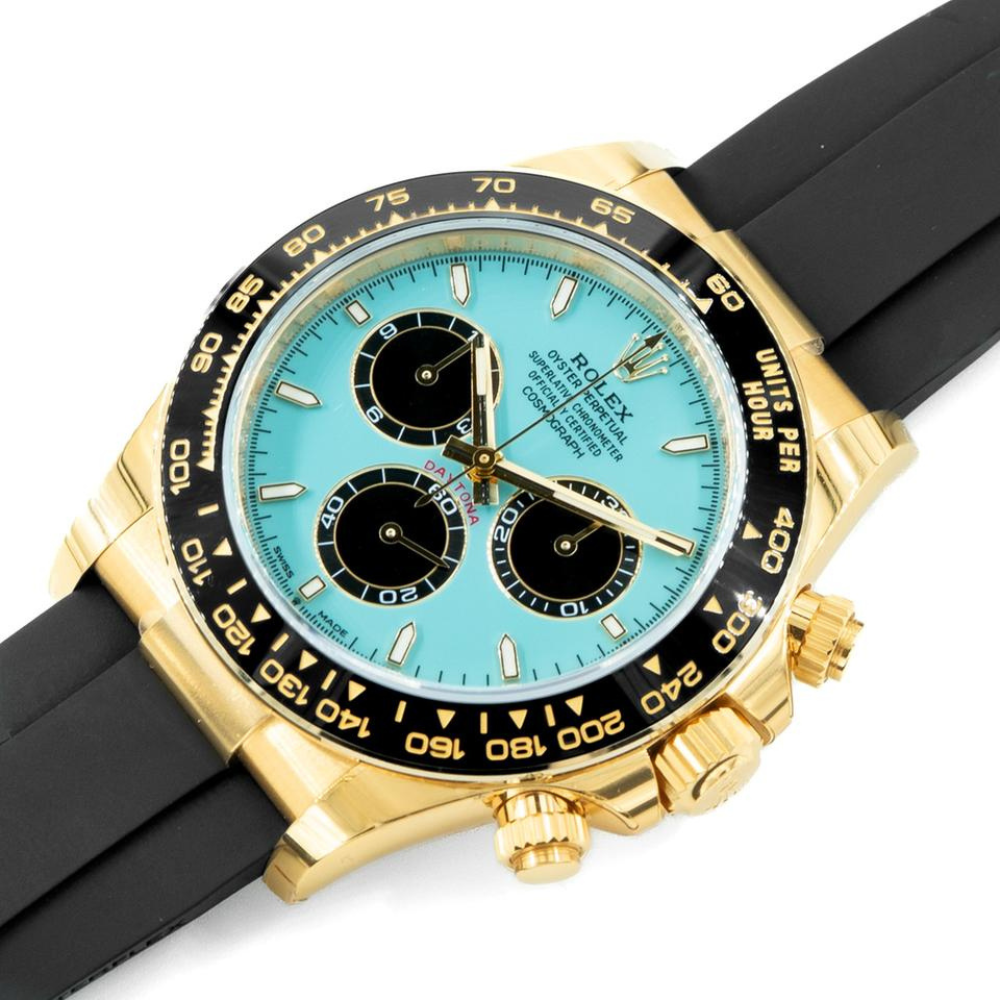 Chronograph, gold case, black bezel, turquoise dial with black sub-dials, black rubber strap